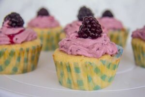lemon cupcake with blackberry frosting