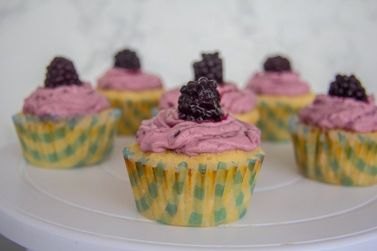 light keto lemon cupcakes with a blackberry topping