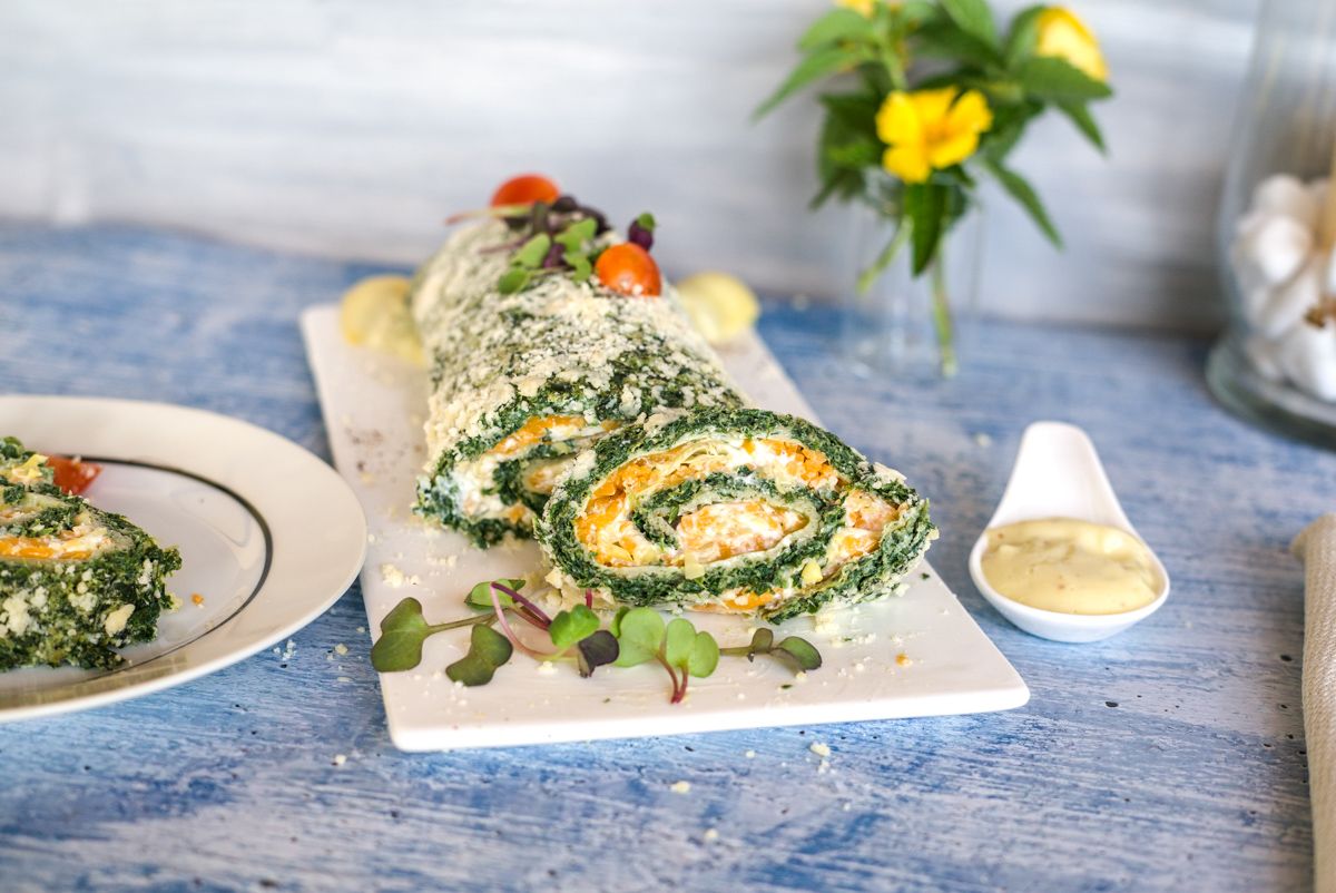spinach cheese roulade on a white plate