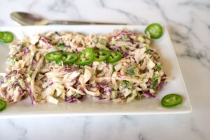 jalapeno coleslaw with sliced jalapenos on a plate