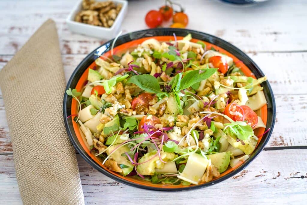 palm hearts, avocado salad in a serving bowl.