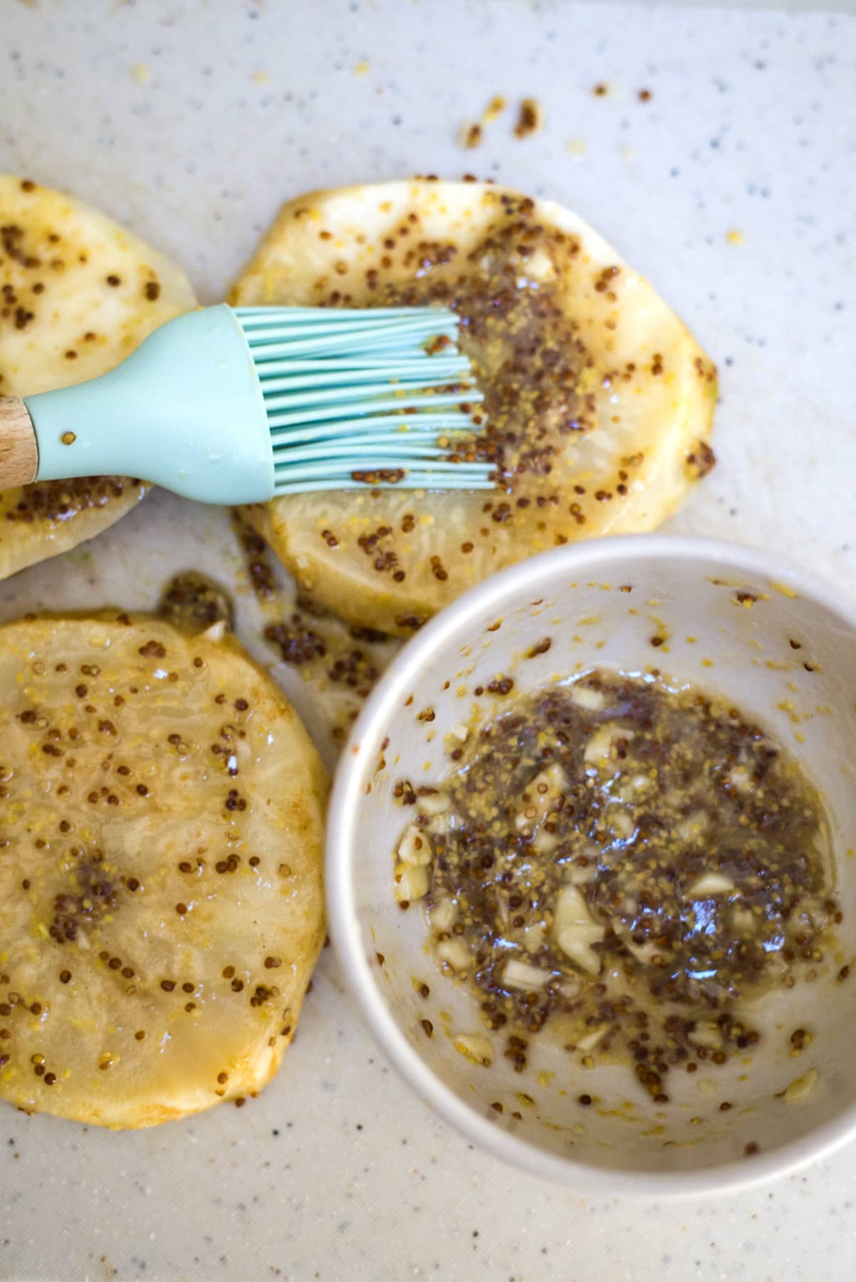 brush celeriac slices with seasoning