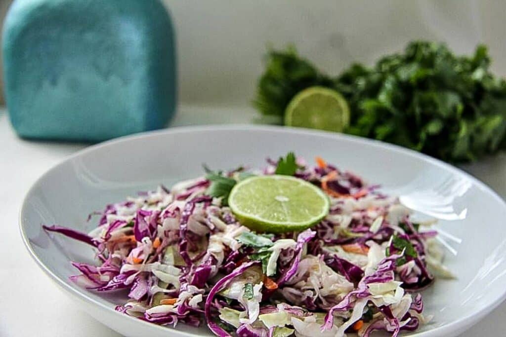 coleslaw with lime and cilantro in a bowl