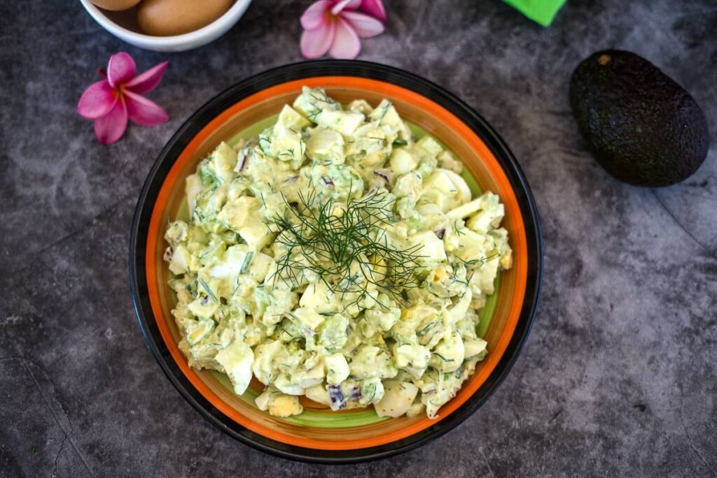 avocado egg salad in a bowl with dill  garnish