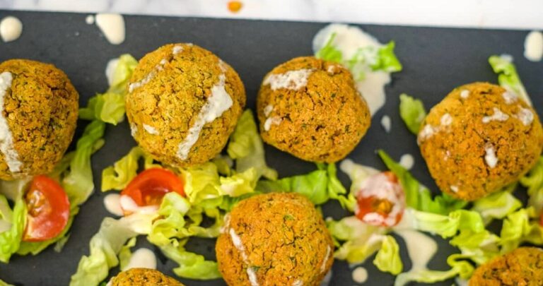 A tray of keto falafel balls and salad on a table.
