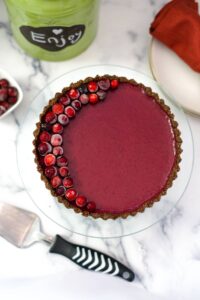 A low carb vegan cranberry tart is sitting on a table.