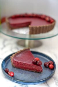A low carb slice of cranberry tart on a plate.