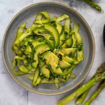 asparagus avocado salad on a circular plate