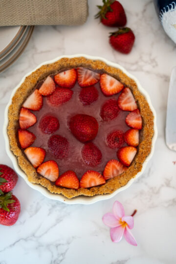 strawberry pie in a dish and decorated with strawberries