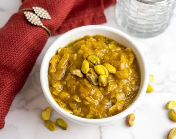 Pumpkin Halwa topped with pistachio nuts in a white bowl.