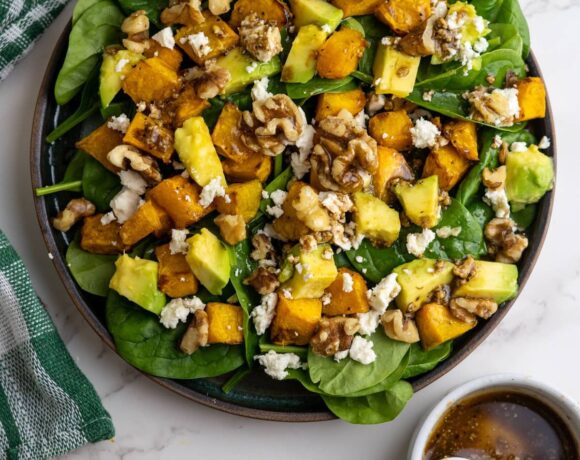 Pumpkin chunks on a bed of spinach with feta cheese, avocado and walnuts.