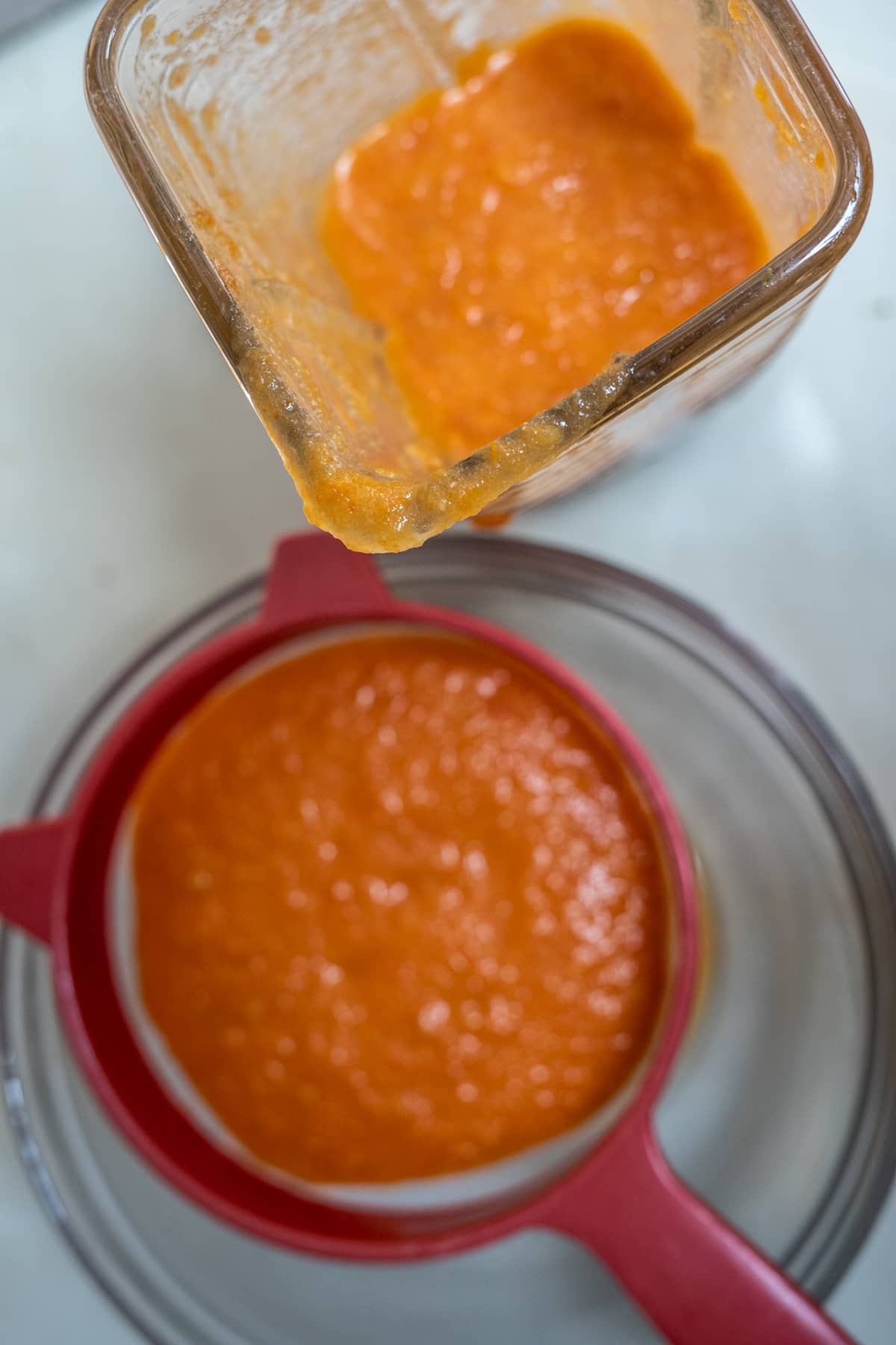 sieving tomatoes