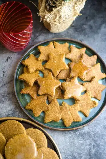 A plate of vegan gingerbread cookies on a table.