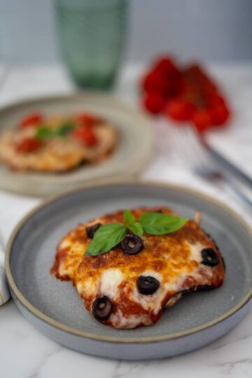 Two portobello mushroom pizzas on a plate.