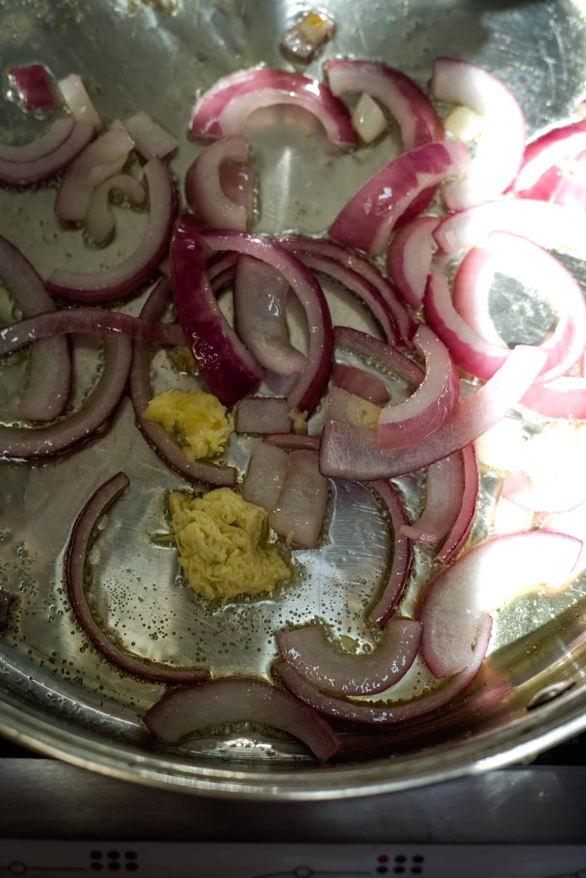 sliced onions and garlic in a large pan