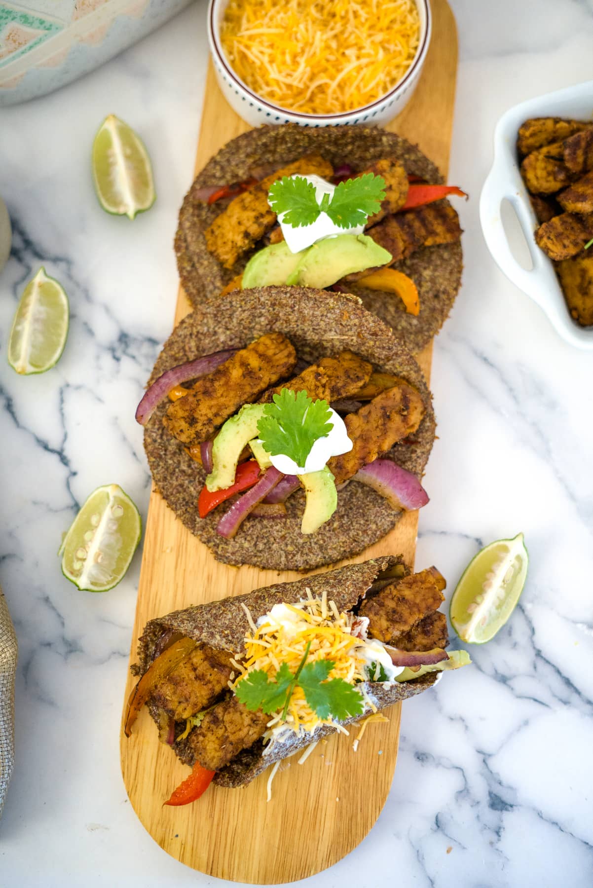 tempeh fajitas on a board with flaxseed tortillas