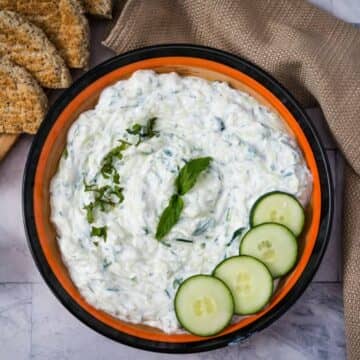 tzatziki sauce in a bowl with cucumber