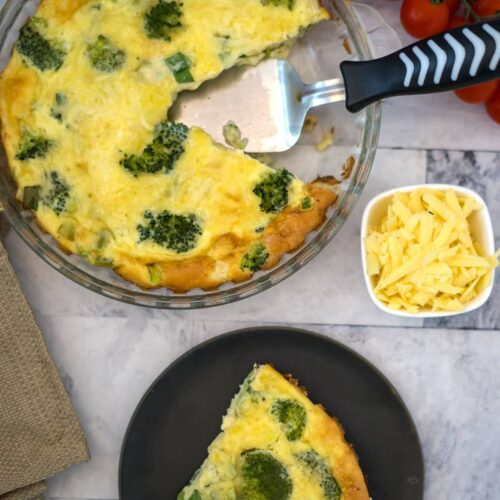 broccoli quiche slice on plate with remaining quiche in dish