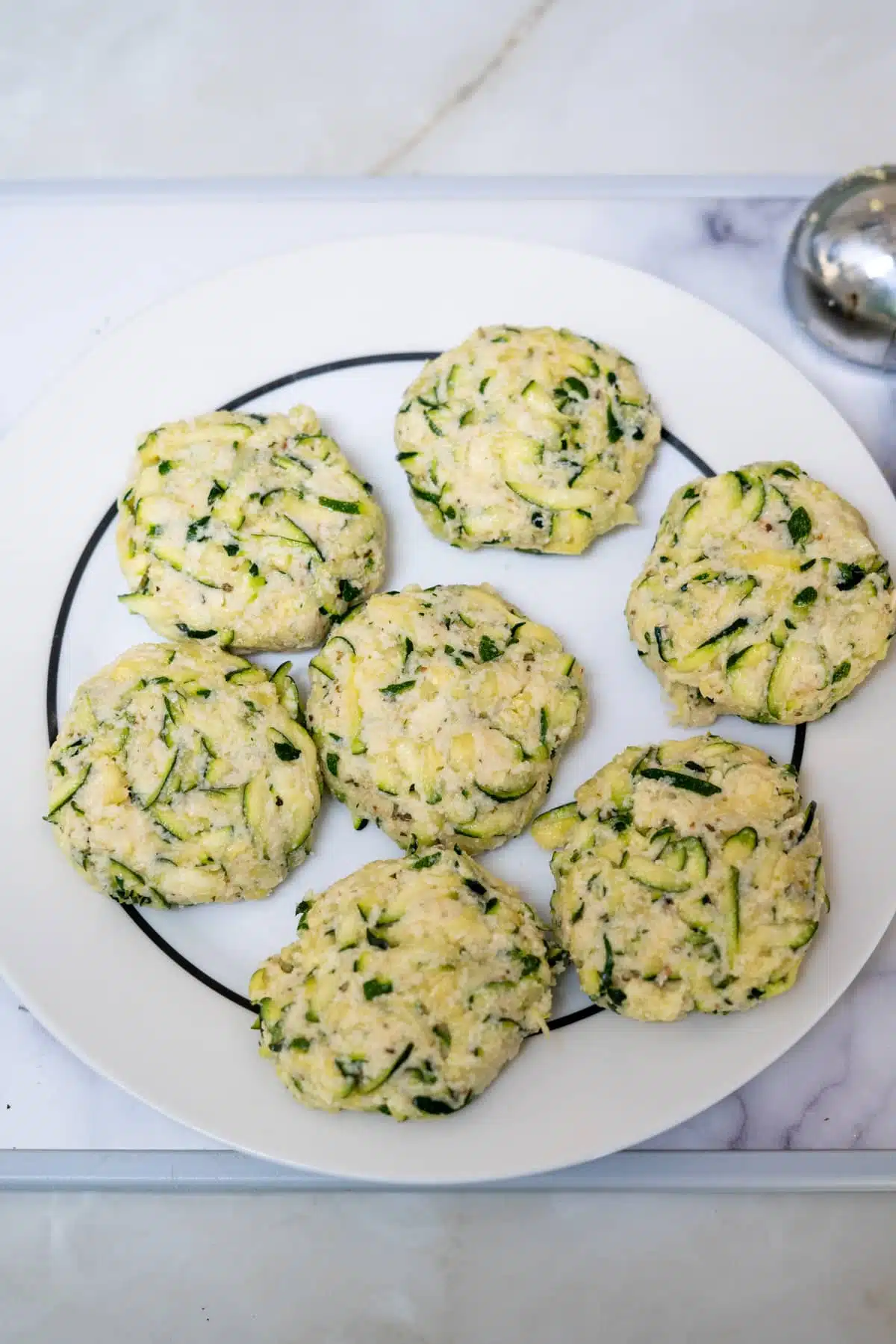 formed zucchini patties on a plate