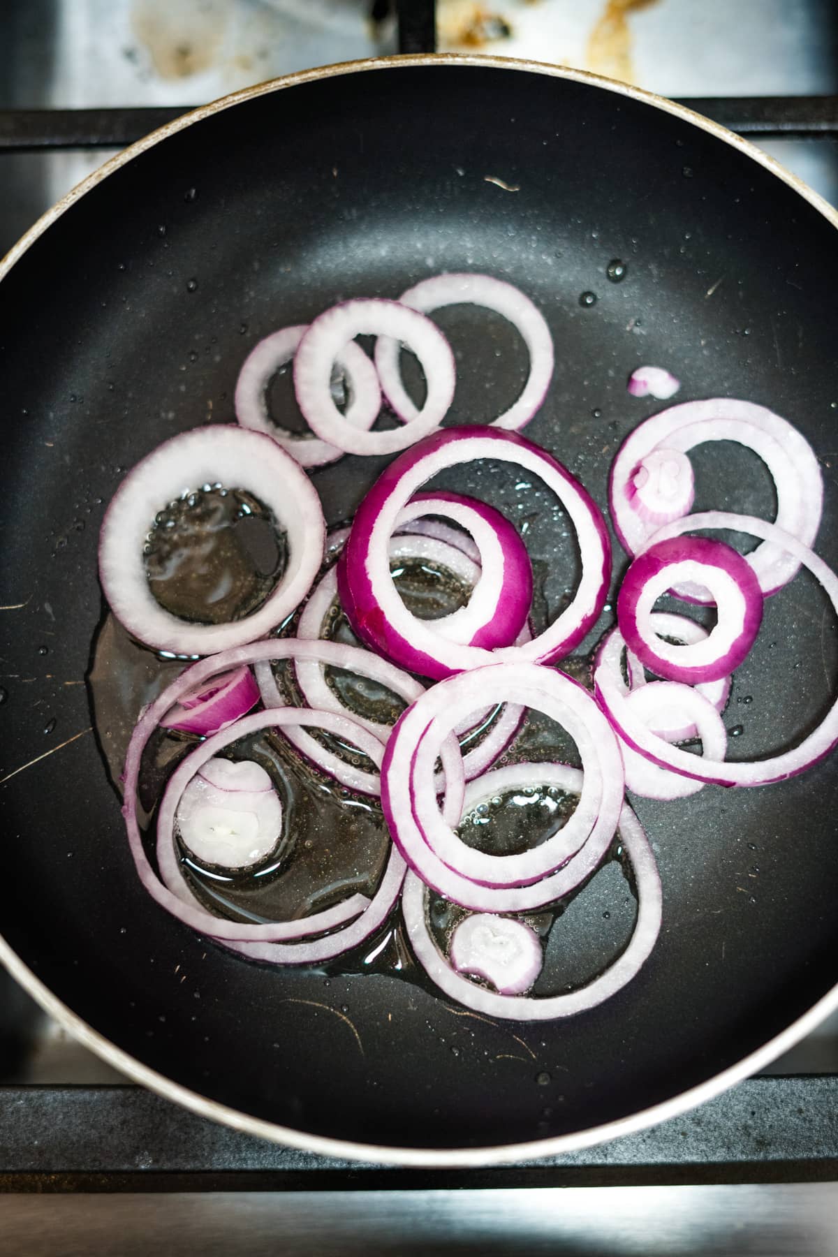 cooked onion rings in pan.