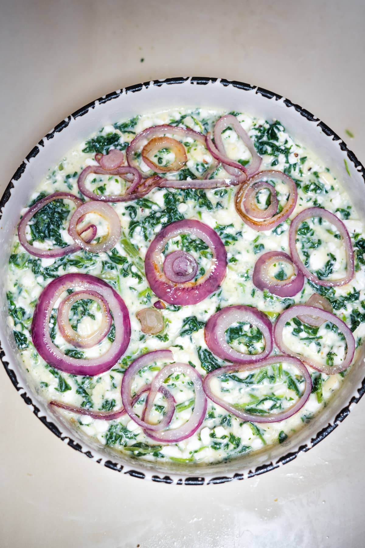 onion rings on top of quiche mixture.