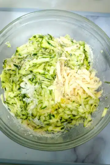 zucchini cheese fritter ingredients in a bowl