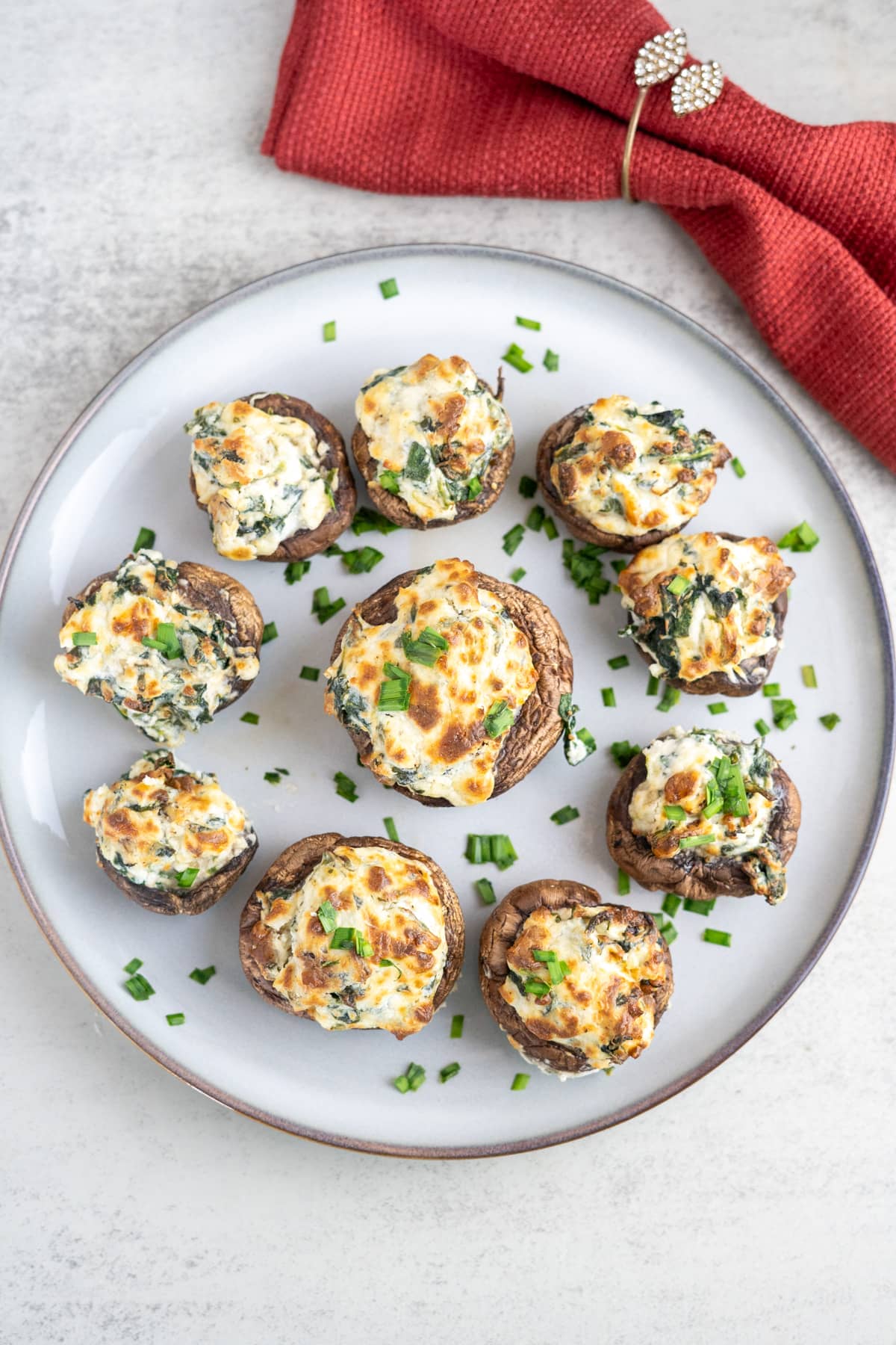 Stuffed mushrooms with spinach and cheese on a plate.