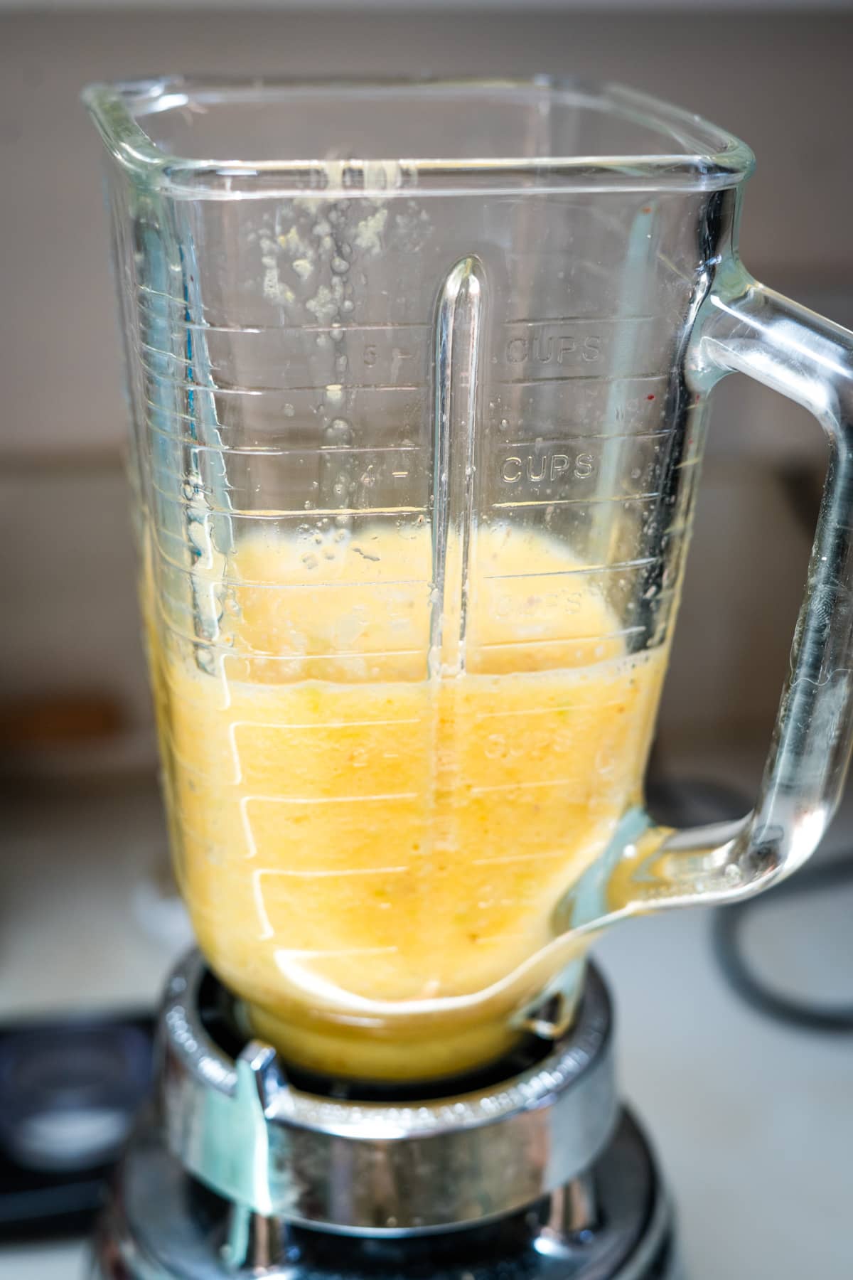 A blender filled with orange juice.