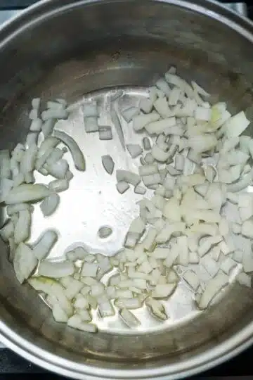 Onions being chopped in a pan for TVP chili.