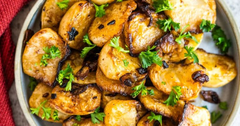 Roasted potatoes in a bowl with parsley.