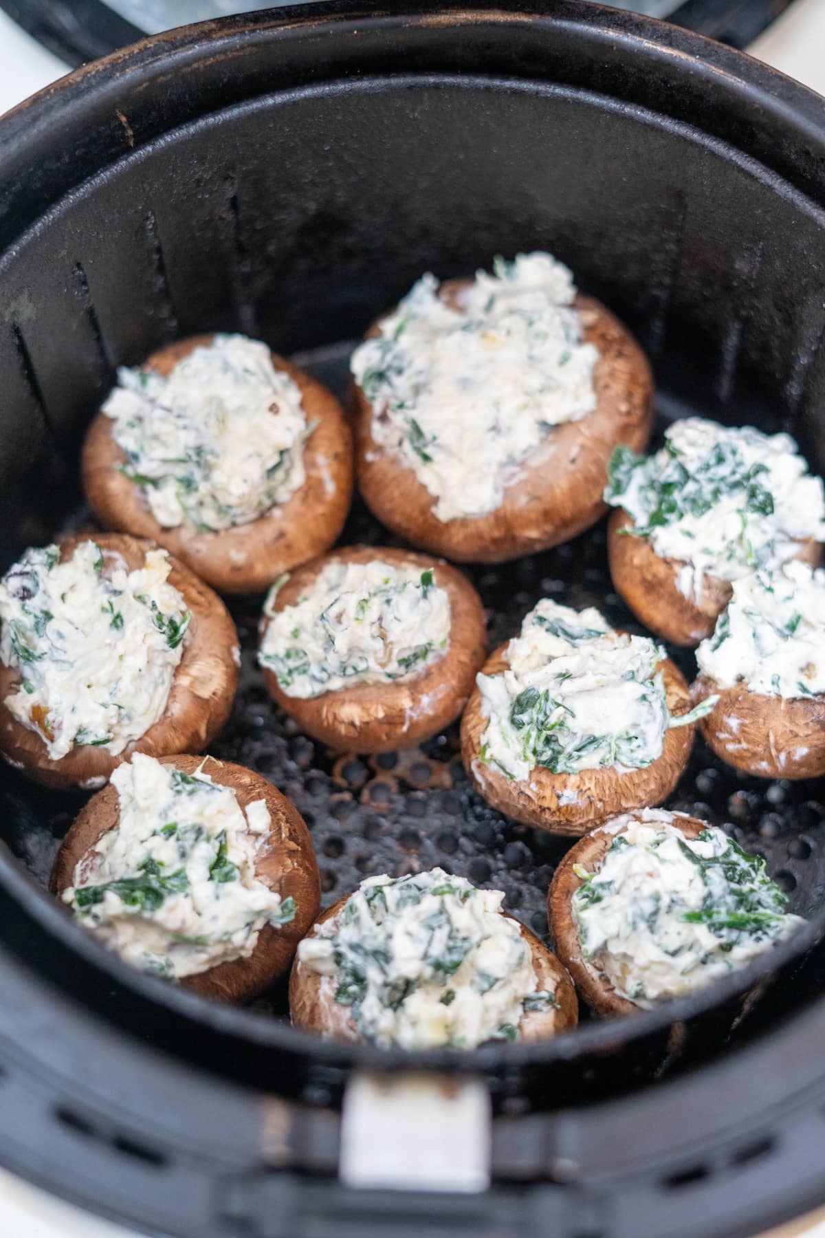 Air fryer stuffed mushrooms with cheese and spinach.