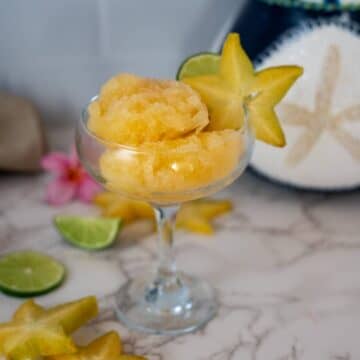 Star fruit ice cream in a martini glass.