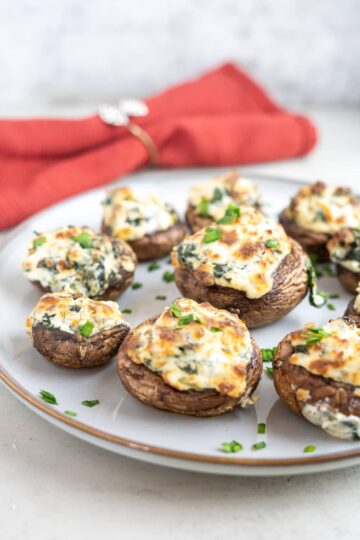 Air fried stuffed mushrooms with spinach and cheese on a plate.