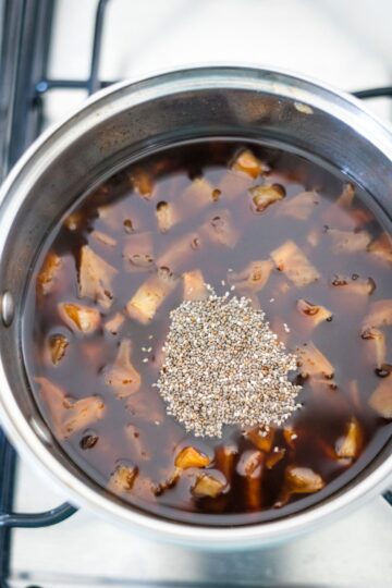 A pan with star fruit jam sauce simmering on top of a stove.