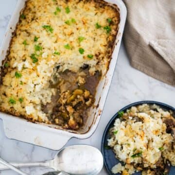 A casserole dish with mashed potatoes and gravy.