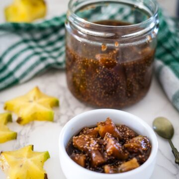 A jar of pineapple chia jam with a spoon next to it.