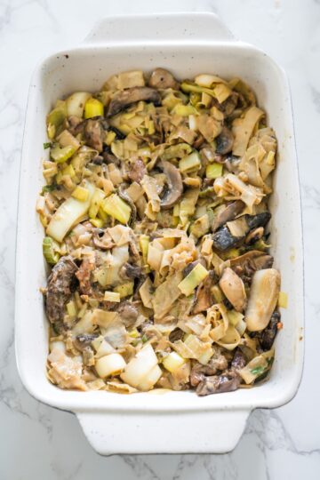 A casserole dish filled with mushroom and leek cottage pie.