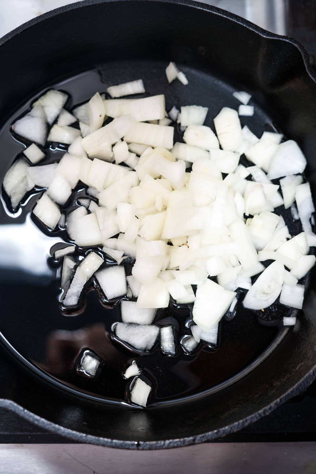 Sliced onions cooked in a cast iron skillet.