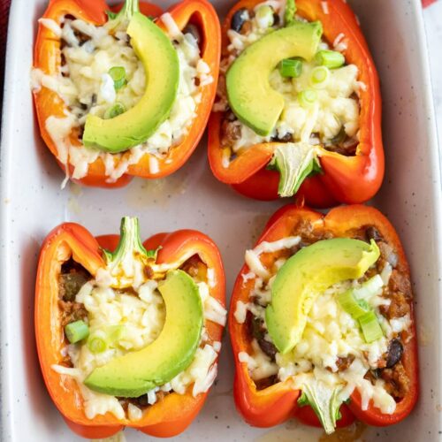 Mexican stuffed peppers in a baking dish.