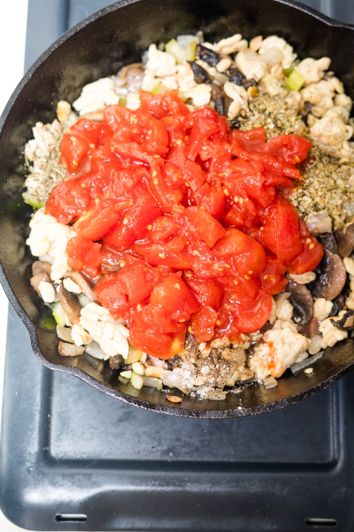 A skillet filled with tempeh and mushrooms.