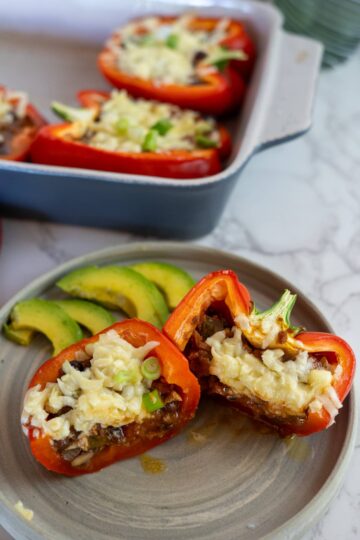 Cheesy chili stuffed peppers on a plate.