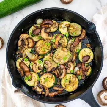 Zucchini and mushrooms in a skillet.