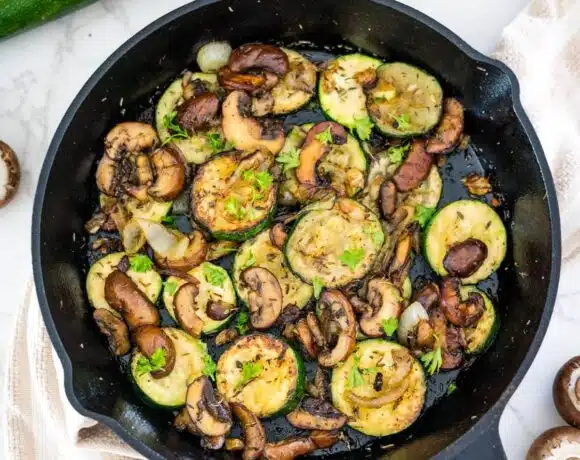 Zucchini and mushrooms in a skillet.