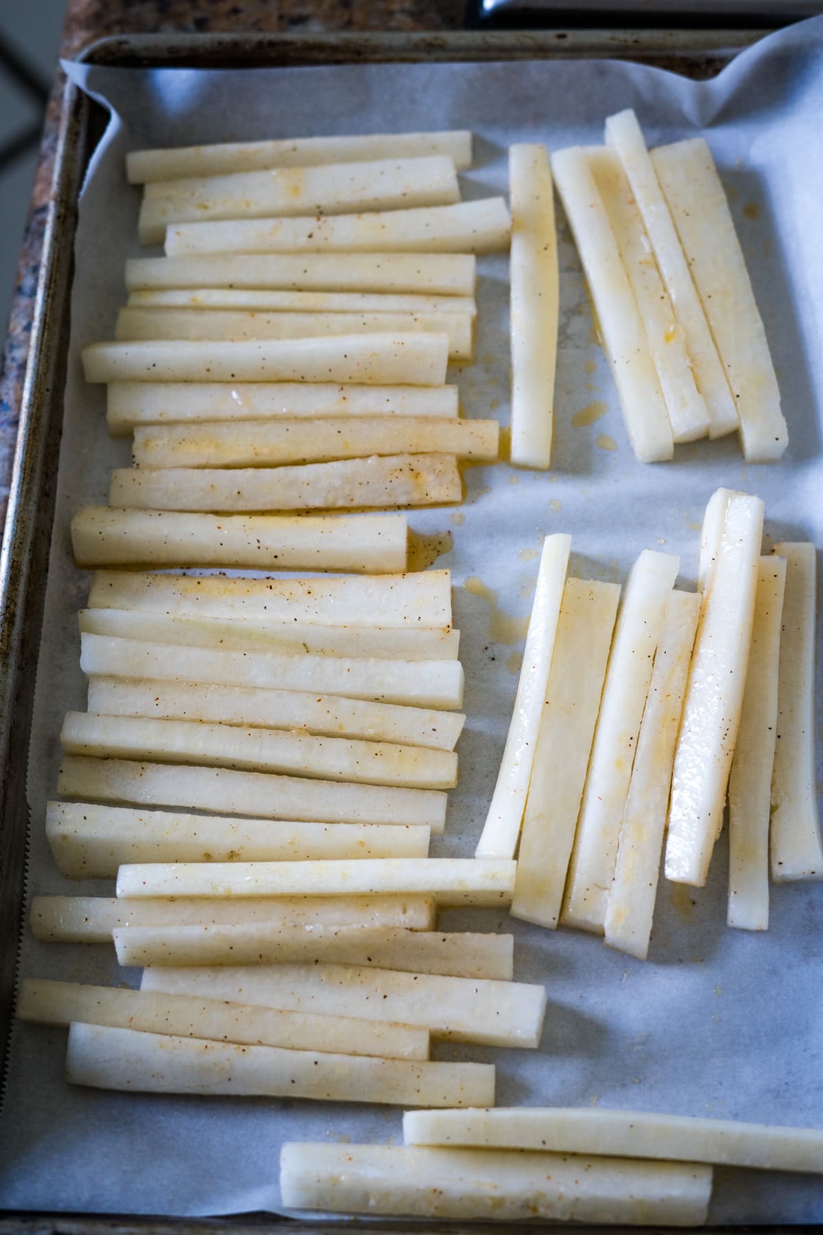 Daikon fries on a baking sheet.