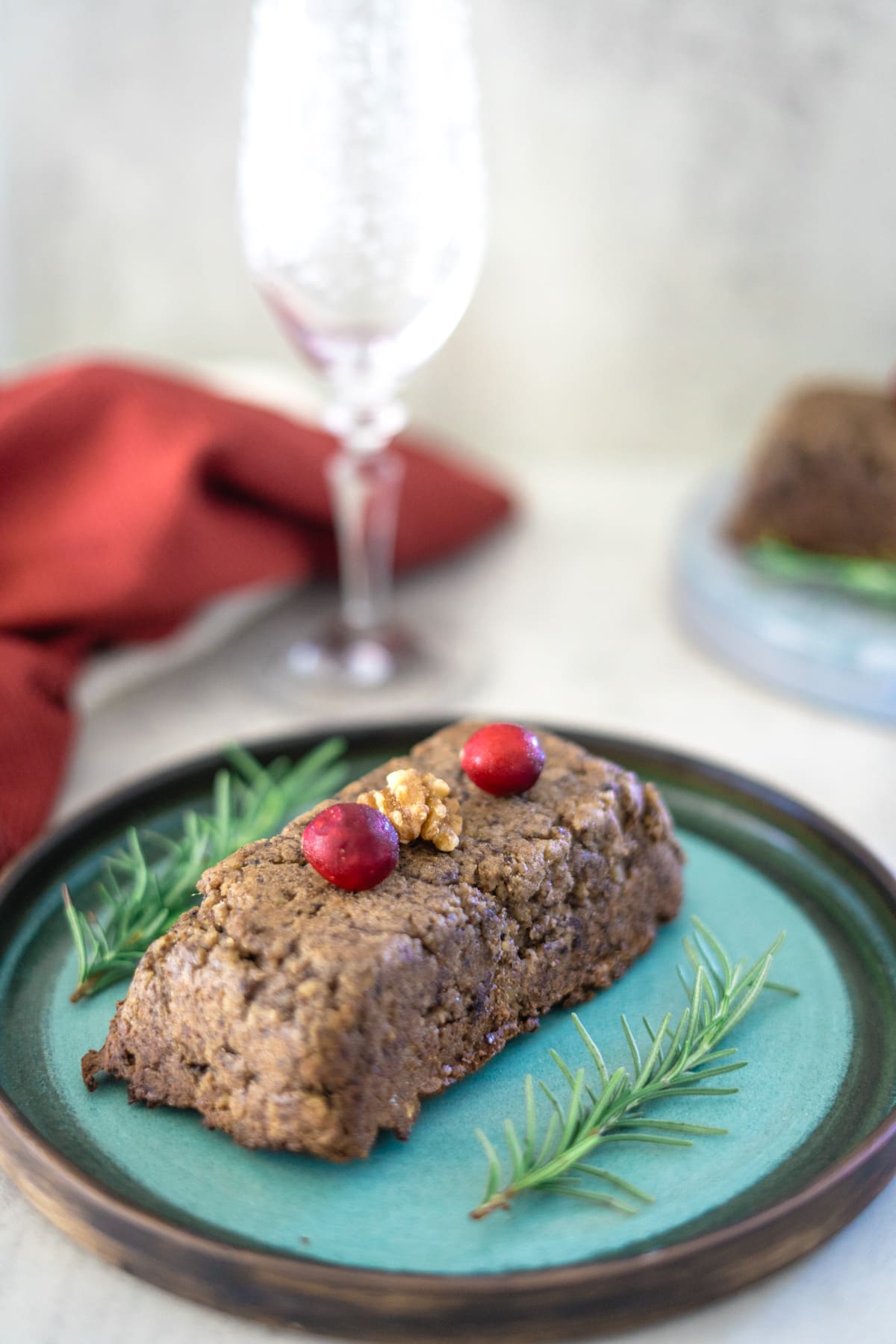 An air fryer nut roast with cranberries and rosemary on a plate.