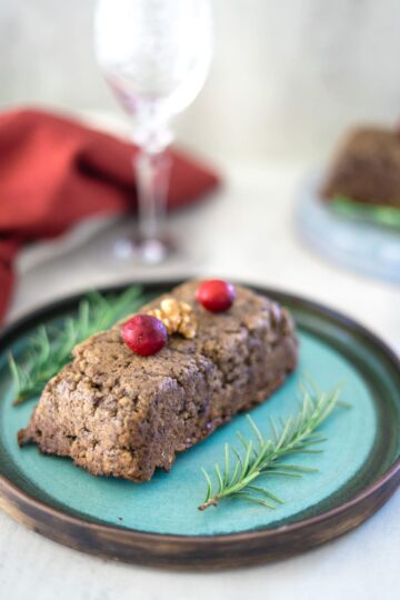 An appetizing plate with a decadent brownie adorned with juicy cranberries.