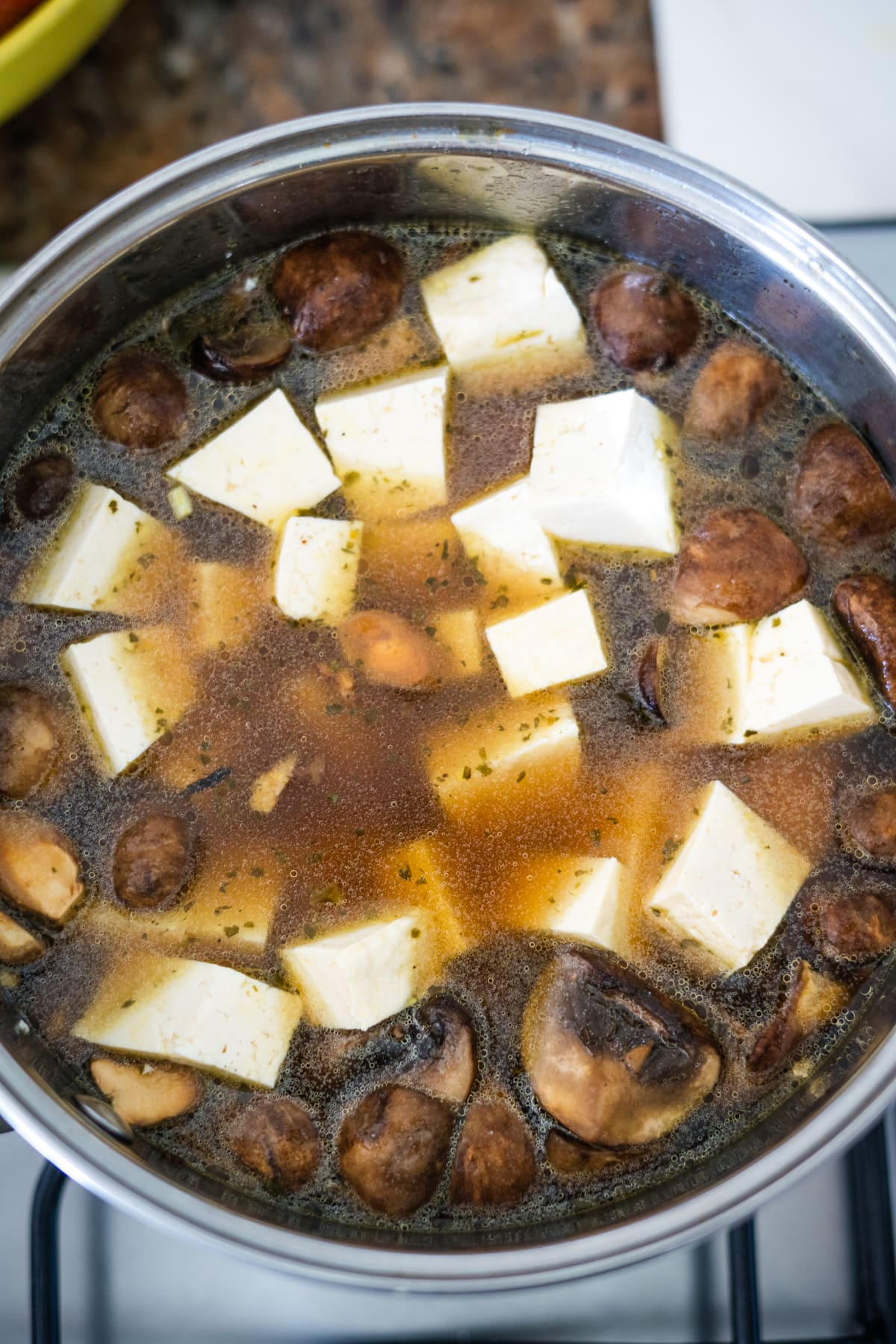 Mushroom and tofu stir-fry on a stove.