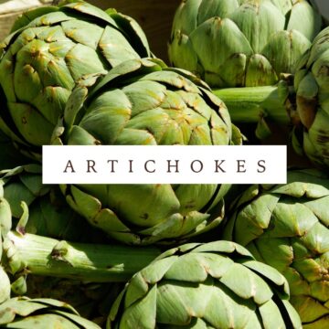 Artichokes in a crate with the words artichokes.
