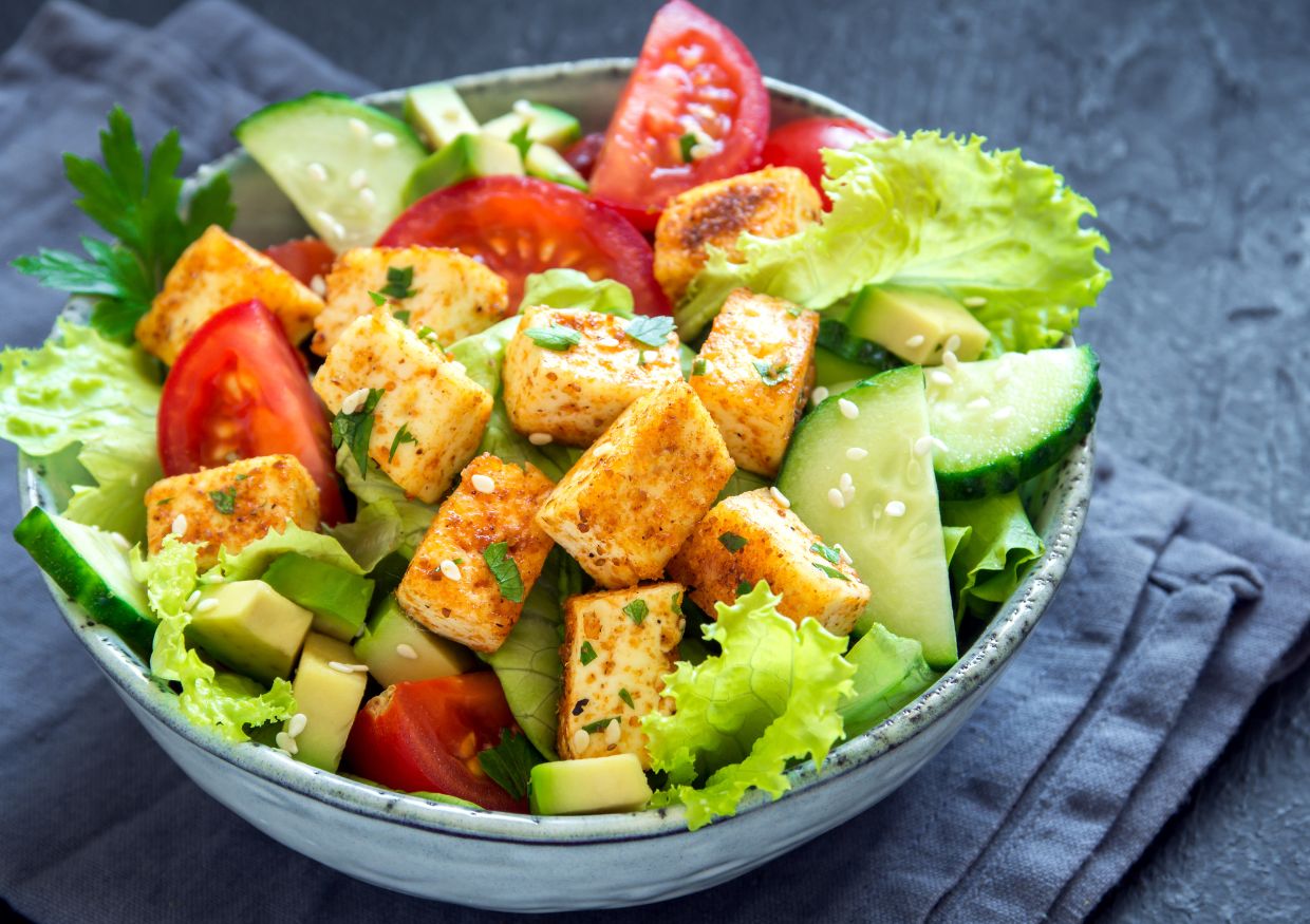 Vegan keto diet-friendly tofu salad in a bowl with tomatoes and cucumbers.