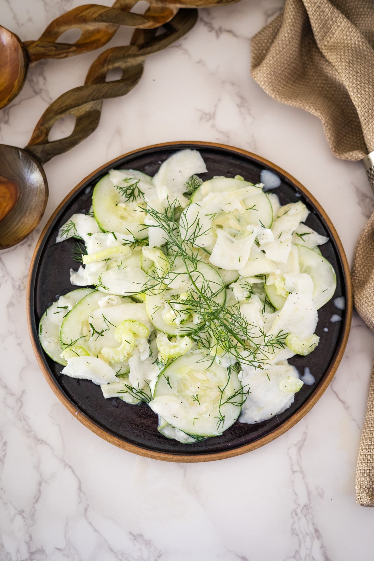 Cucumber and fennel salad with dill on a plate.
